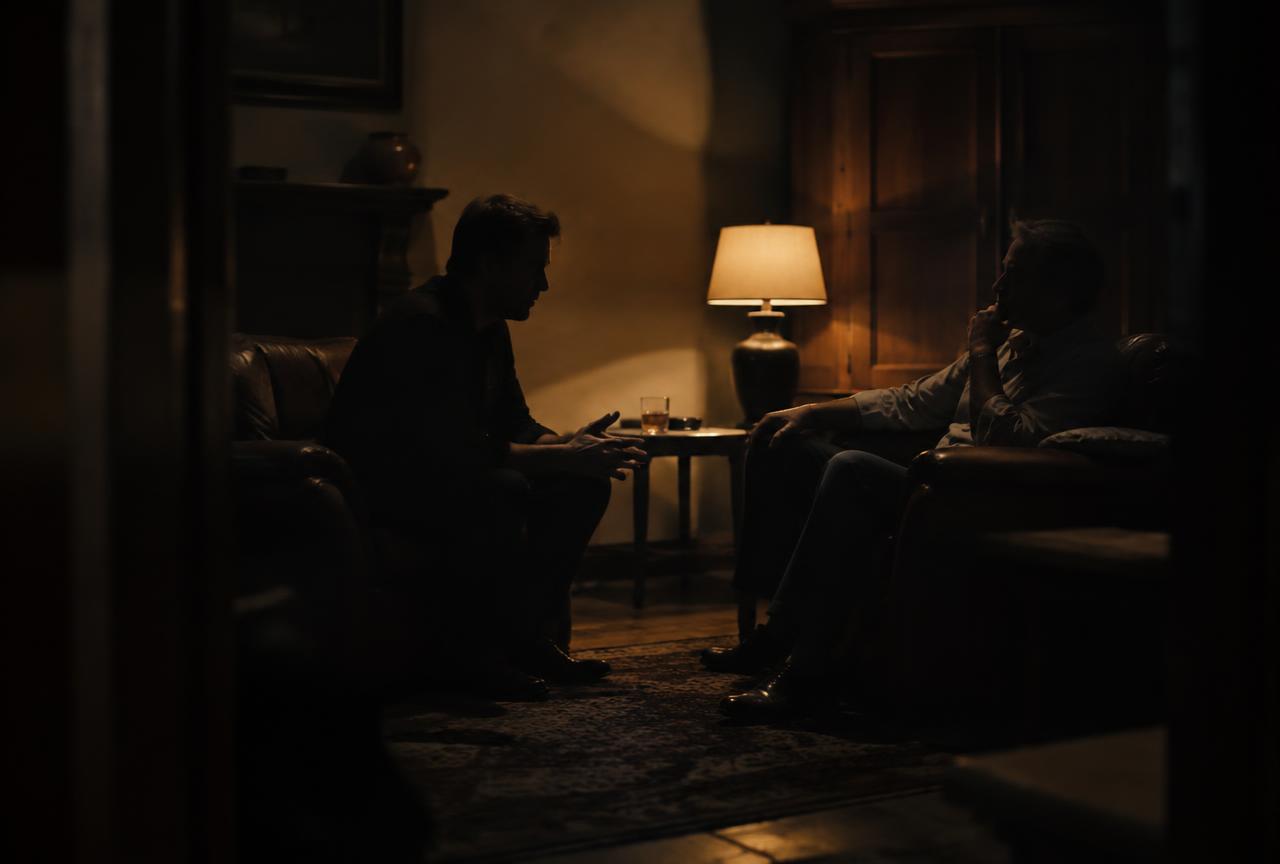 A man mid-conversation, in warm light